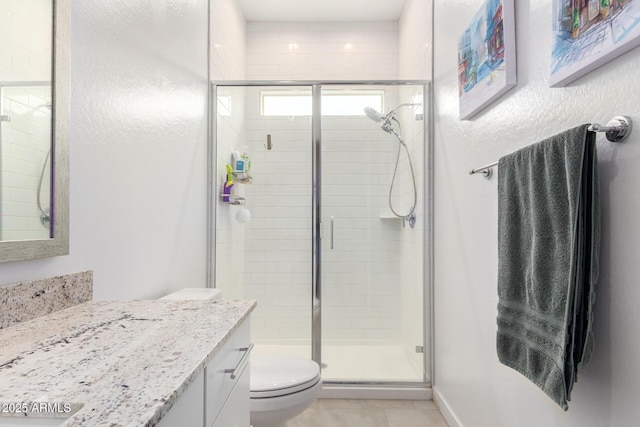 bathroom featuring vanity, toilet, and an enclosed shower