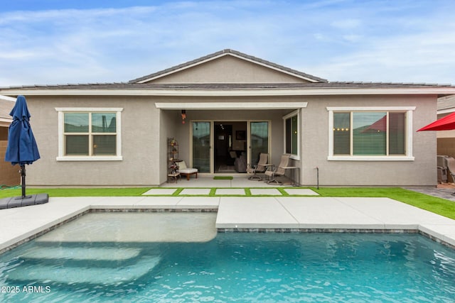 back of property with a patio area