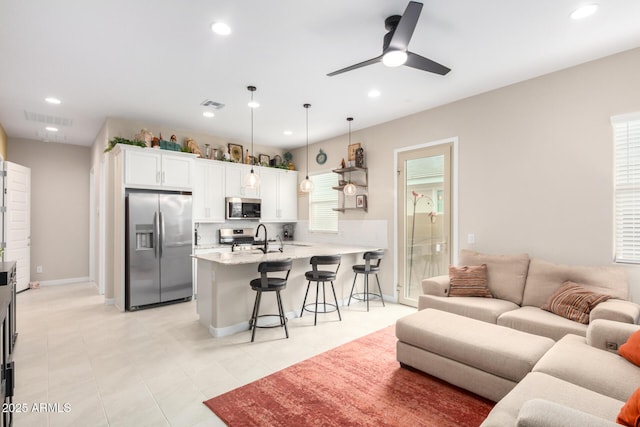 living room featuring sink and ceiling fan