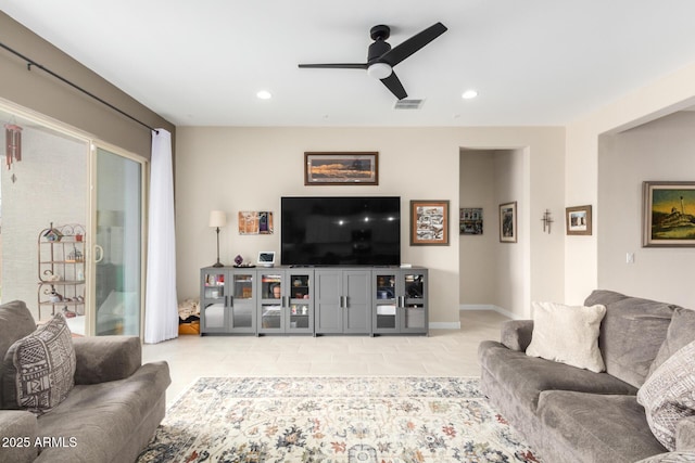 living room with light tile patterned flooring and ceiling fan