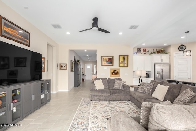 tiled living room with ceiling fan