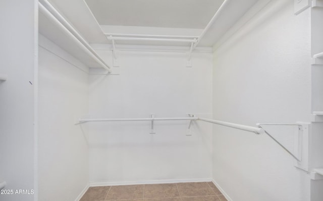 9450 E Becker Ln Unit 1102, Scottsdale, AZ 85260 - walk in closet with light tile patterned floors
