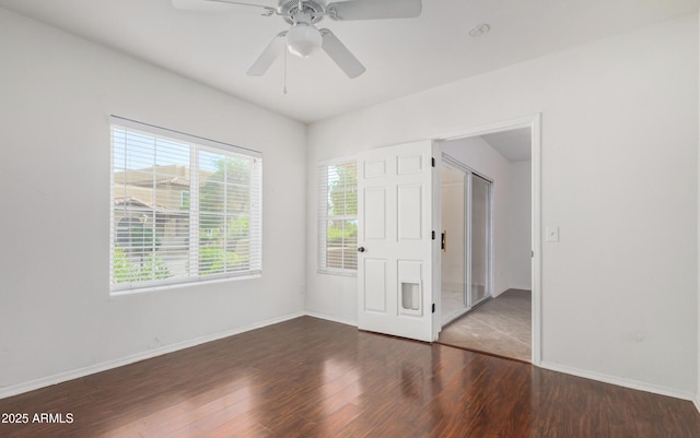 9450 E Becker Ln Unit 1102, Scottsdale, AZ 85260 - unfurnished bedroom with wood finished floors, baseboards, and a ceiling fan