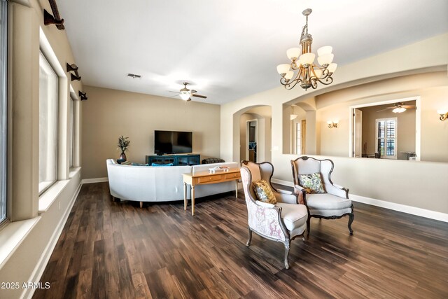2565 N 141st Ln, Goodyear, AZ 85395 - living area featuring a ceiling fan, arched walkways, dark wood finished floors, and a chandelier