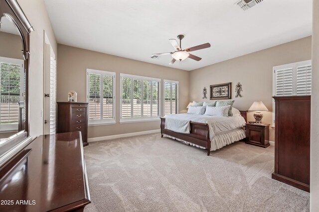 2565 N 141st Ln, Goodyear, AZ 85395 - bedroom featuring light carpet, baseboards, and a ceiling fan