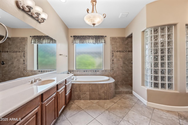 2565 N 141st Ln, Goodyear, AZ 85395 - full bathroom with tile patterned floors, walk in shower, a garden tub, and vanity