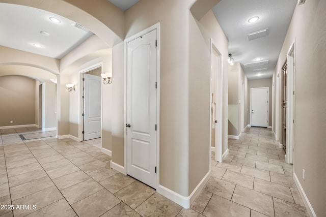 2565 N 141st Ln, Goodyear, AZ 85395 - hall with arched walkways, light tile patterned floors, baseboards, and recessed lighting