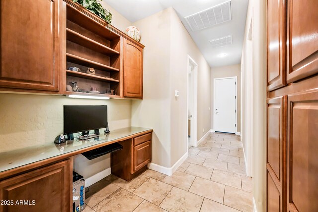 2565 N 141st Ln, Goodyear, AZ 85395 - office with built in desk, baseboards, and light tile patterned floors