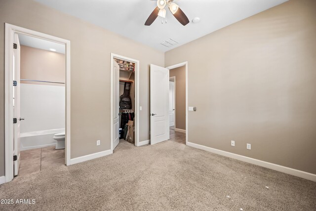 2565 N 141st Ln, Goodyear, AZ 85395 - unfurnished bedroom featuring carpet, baseboards, a spacious closet, ensuite bathroom, and a closet