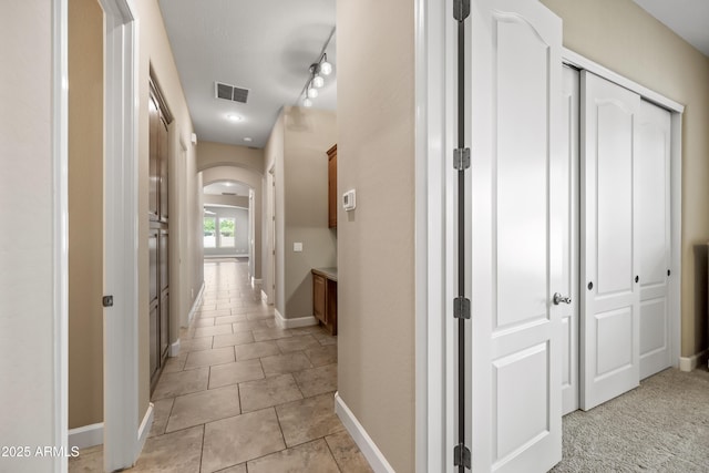 2565 N 141st Ln, Goodyear, AZ 85395 - corridor with arched walkways, light tile patterned floors, and baseboards