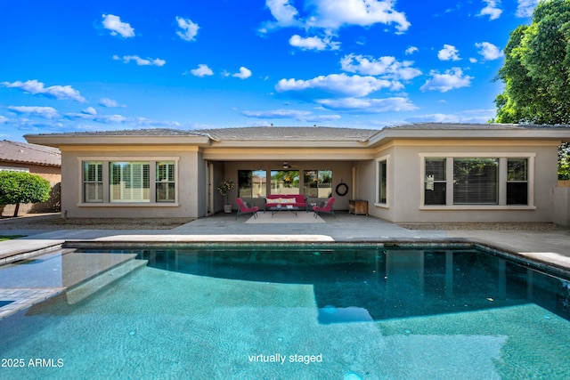 2565 N 141st Ln, Goodyear, AZ 85395 - back of house with an outdoor living space, a patio area, an outdoor pool, and stucco siding