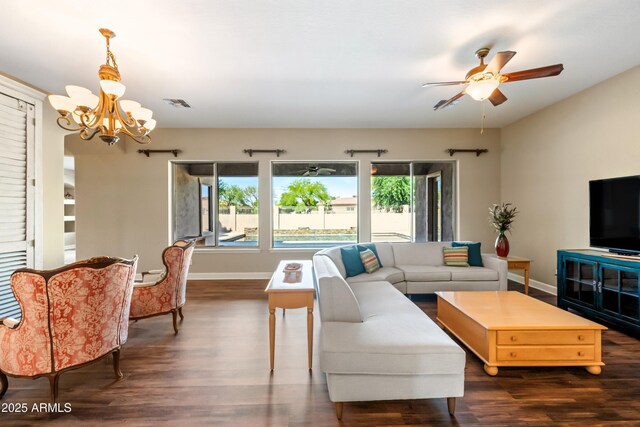 2565 N 141st Ln, Goodyear, AZ 85395 - living area featuring a chandelier, a ceiling fan, dark wood finished floors, and baseboards