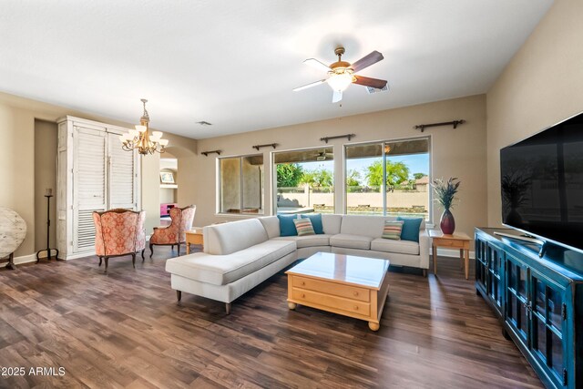 2565 N 141st Ln, Goodyear, AZ 85395 - living area featuring a chandelier, ceiling fan, dark wood-type flooring, and baseboards