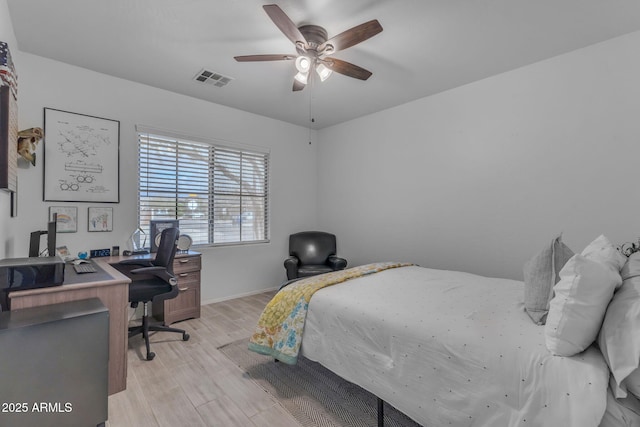 bedroom with visible vents, light wood-style flooring, baseboards, and a ceiling fan