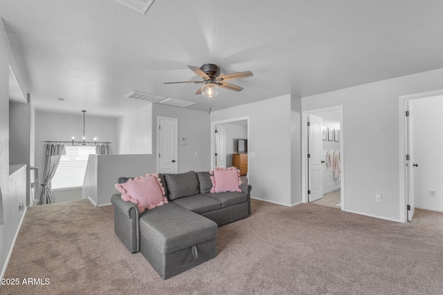 living area featuring visible vents, baseboards, light colored carpet, and ceiling fan with notable chandelier