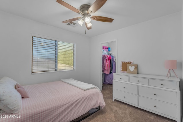 carpeted bedroom with visible vents, a ceiling fan, a closet, and a spacious closet