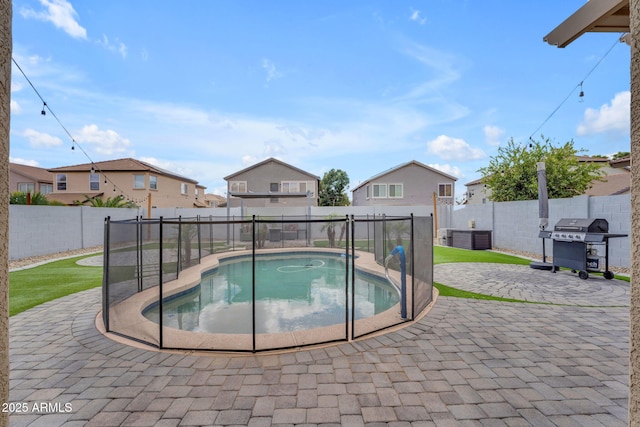 view of swimming pool featuring a patio, a fenced backyard, and a grill