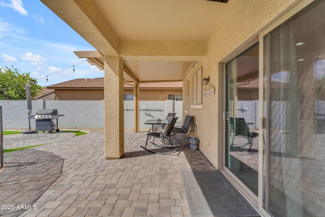 view of patio / terrace with area for grilling and fence