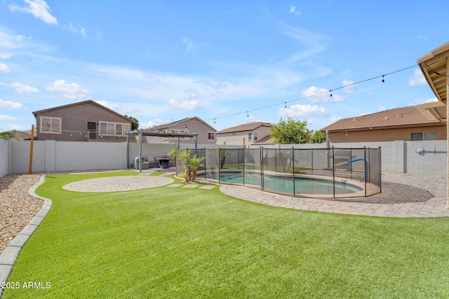 view of yard featuring a fenced backyard, a fenced in pool, and a patio