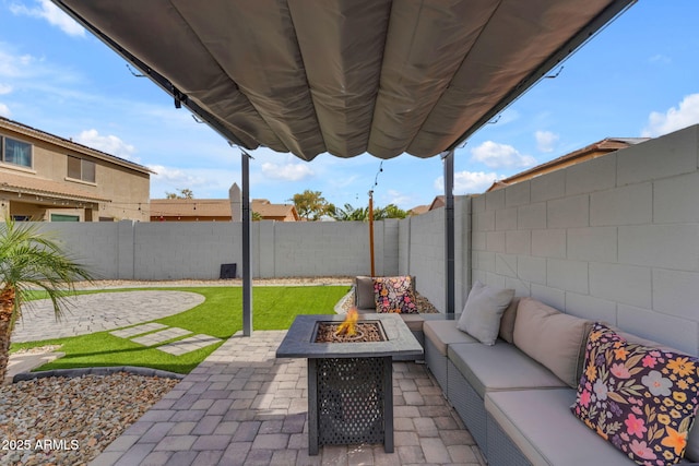 view of patio with an outdoor living space with a fire pit and a fenced backyard