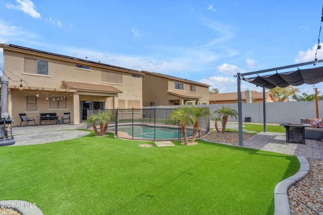 view of yard featuring a patio area, a fenced in pool, and a fenced backyard