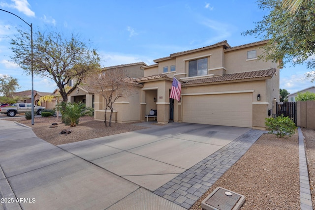 view of front of home featuring fence, stucco siding, concrete driveway, a garage, and a tiled roof