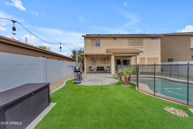 back of property with stucco siding, a patio, a fenced backyard, a yard, and a fenced in pool