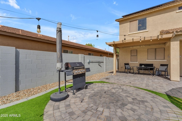 view of patio / terrace with area for grilling and a fenced backyard