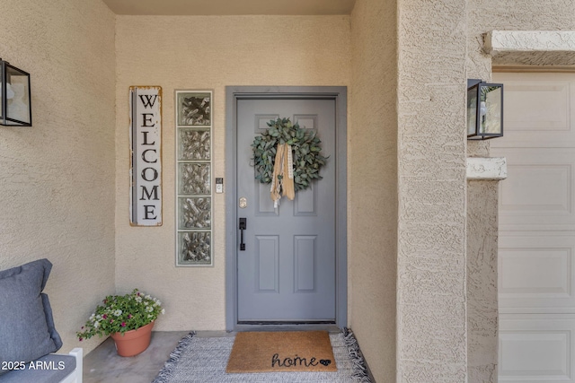 doorway to property with stucco siding