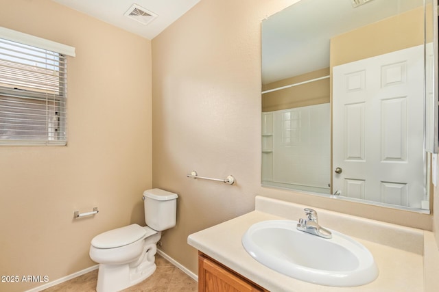 bathroom featuring vanity, baseboards, visible vents, tile patterned floors, and toilet