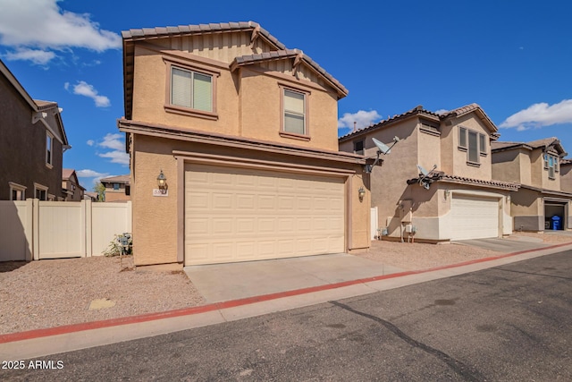 view of front of property with fence, stucco siding, concrete driveway, a garage, and a tile roof