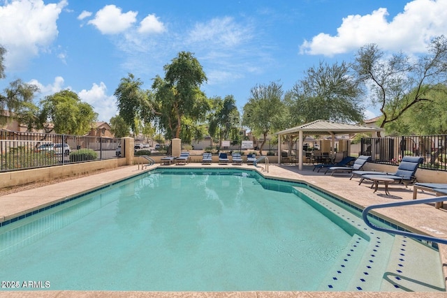 community pool featuring a gazebo, a patio area, and fence