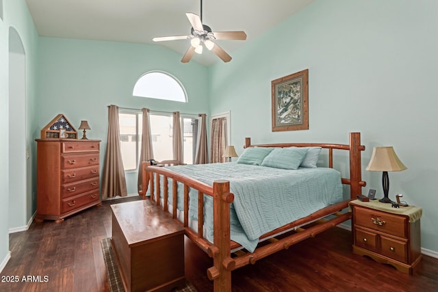 bedroom featuring ceiling fan, dark wood-type flooring, and vaulted ceiling