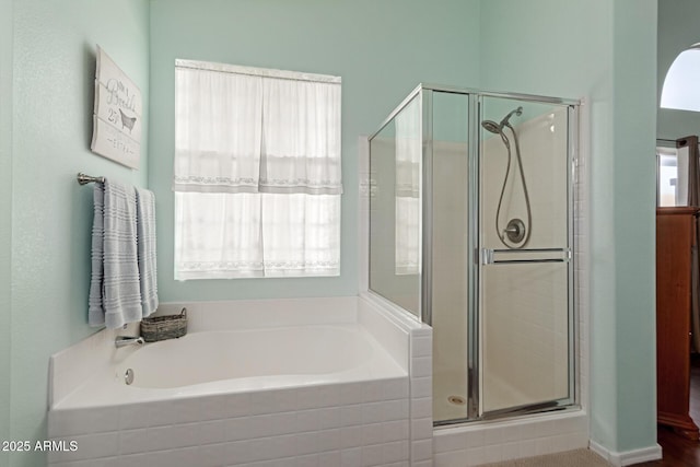 bathroom featuring separate shower and tub