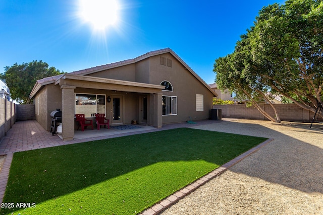 back of property with a patio and a yard