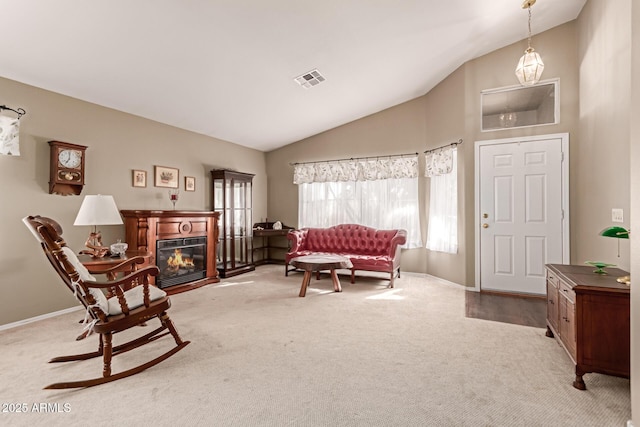 living area with vaulted ceiling and carpet floors