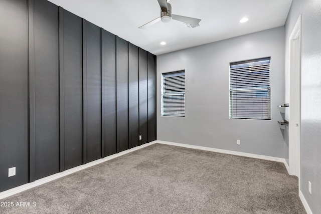 empty room featuring ceiling fan and carpet floors