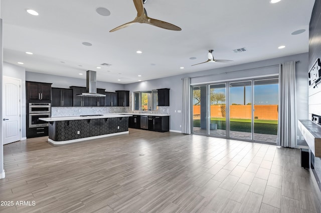 unfurnished living room featuring ceiling fan