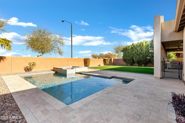 view of swimming pool with a lawn and an in ground hot tub