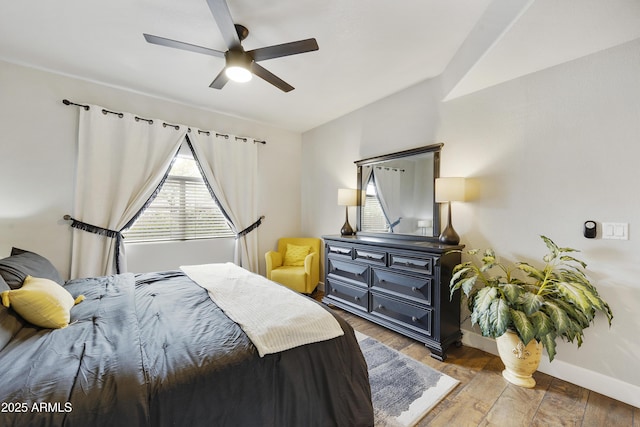 bedroom featuring baseboards, ceiling fan, and wood finished floors