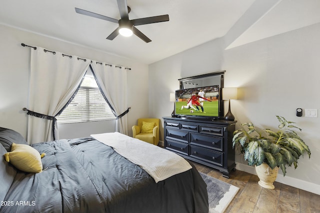 bedroom with baseboards, wood finished floors, and a ceiling fan