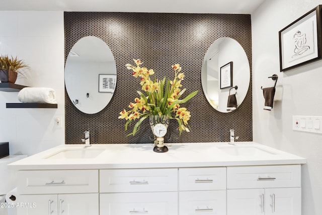 full bathroom with double vanity, backsplash, and a sink