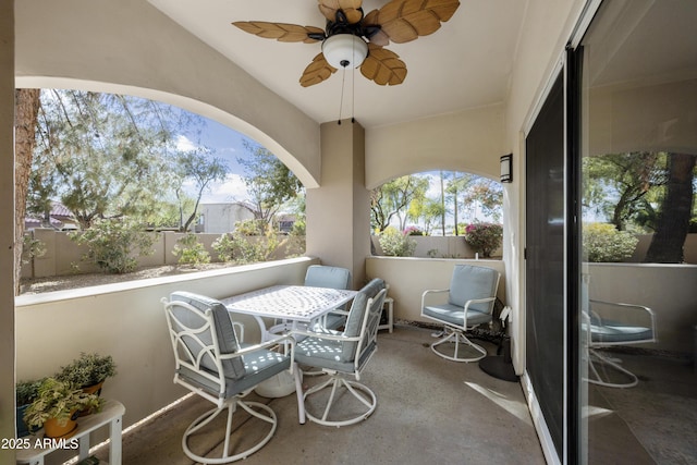 view of patio featuring ceiling fan and fence