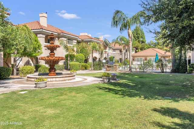 view of home's community featuring a yard and fence