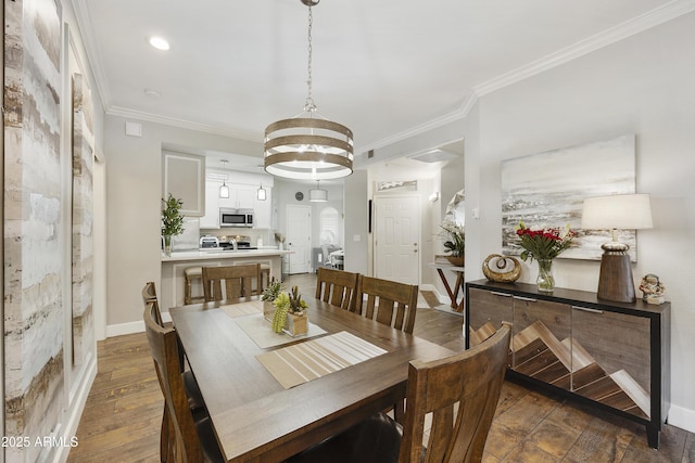 dining space with crown molding, baseboards, and wood-type flooring