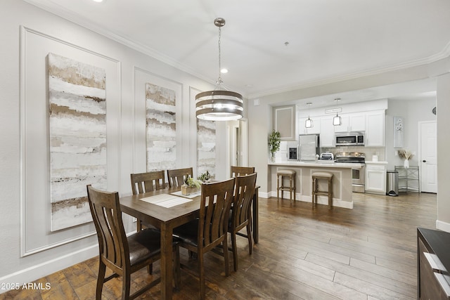 dining room featuring dark wood-type flooring, baseboards, and ornamental molding