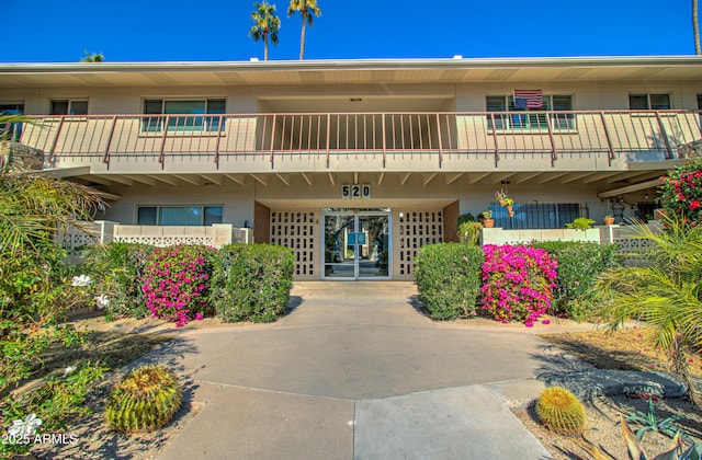 view of building exterior featuring a carport and concrete driveway