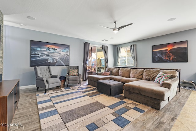 living area with ceiling fan, visible vents, baseboards, and wood finish floors