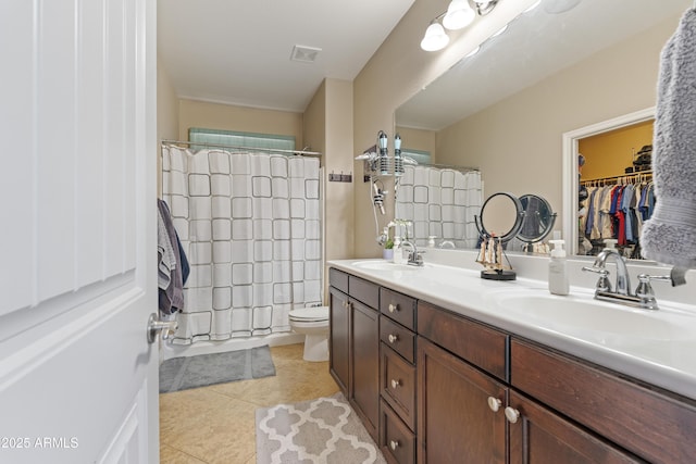 full bath featuring double vanity, visible vents, a sink, and tile patterned floors