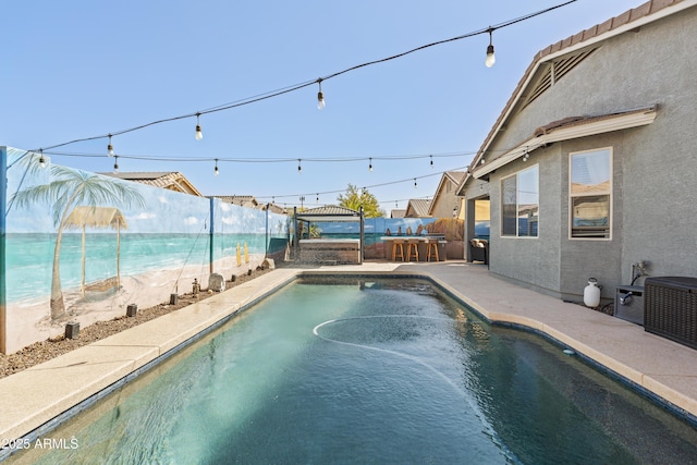 pool with a patio and a fenced backyard